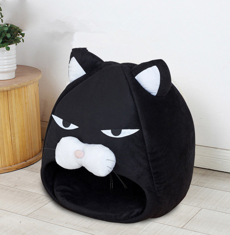 Black cat-shaped pet bed on a light wooden floor with a white wall background