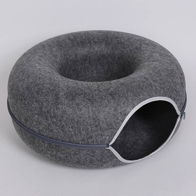 Gray donut-shaped pet bed with a zipper on a light gray background