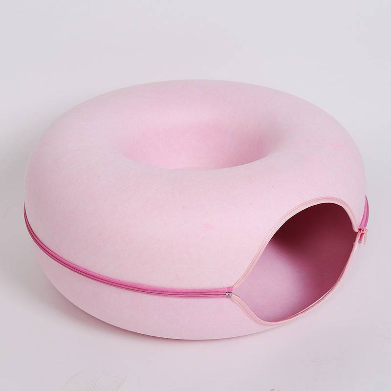 Pink pet house with a zipper on a light gray background
