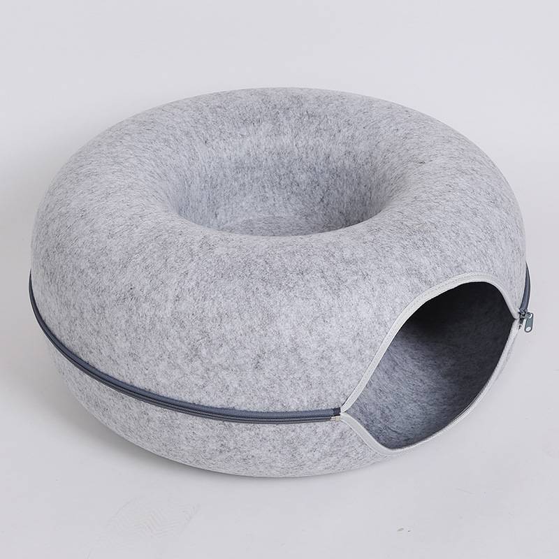 Gray donut-shaped pillow on a light gray background